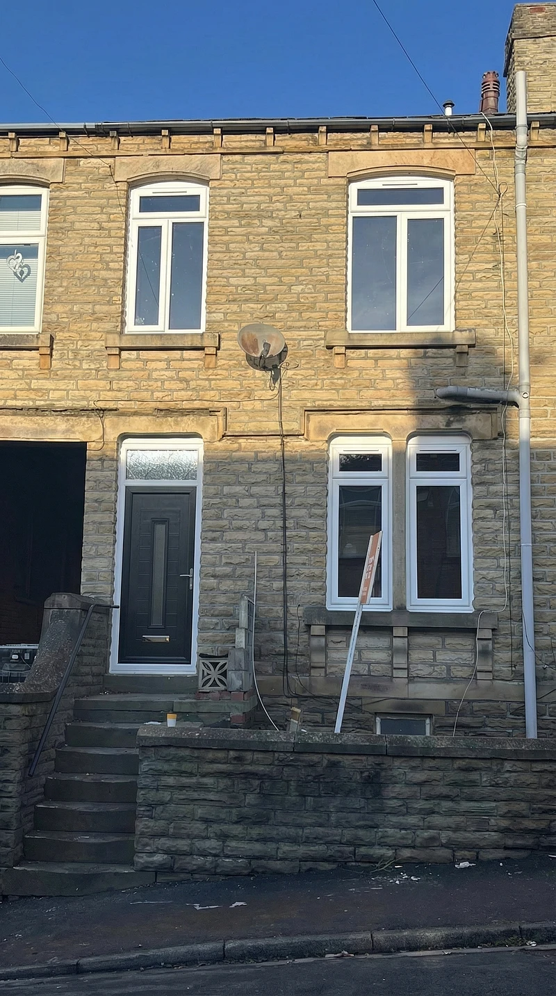 Yorkshire stone terraced house with new white uPVC windows and anthracite composite door